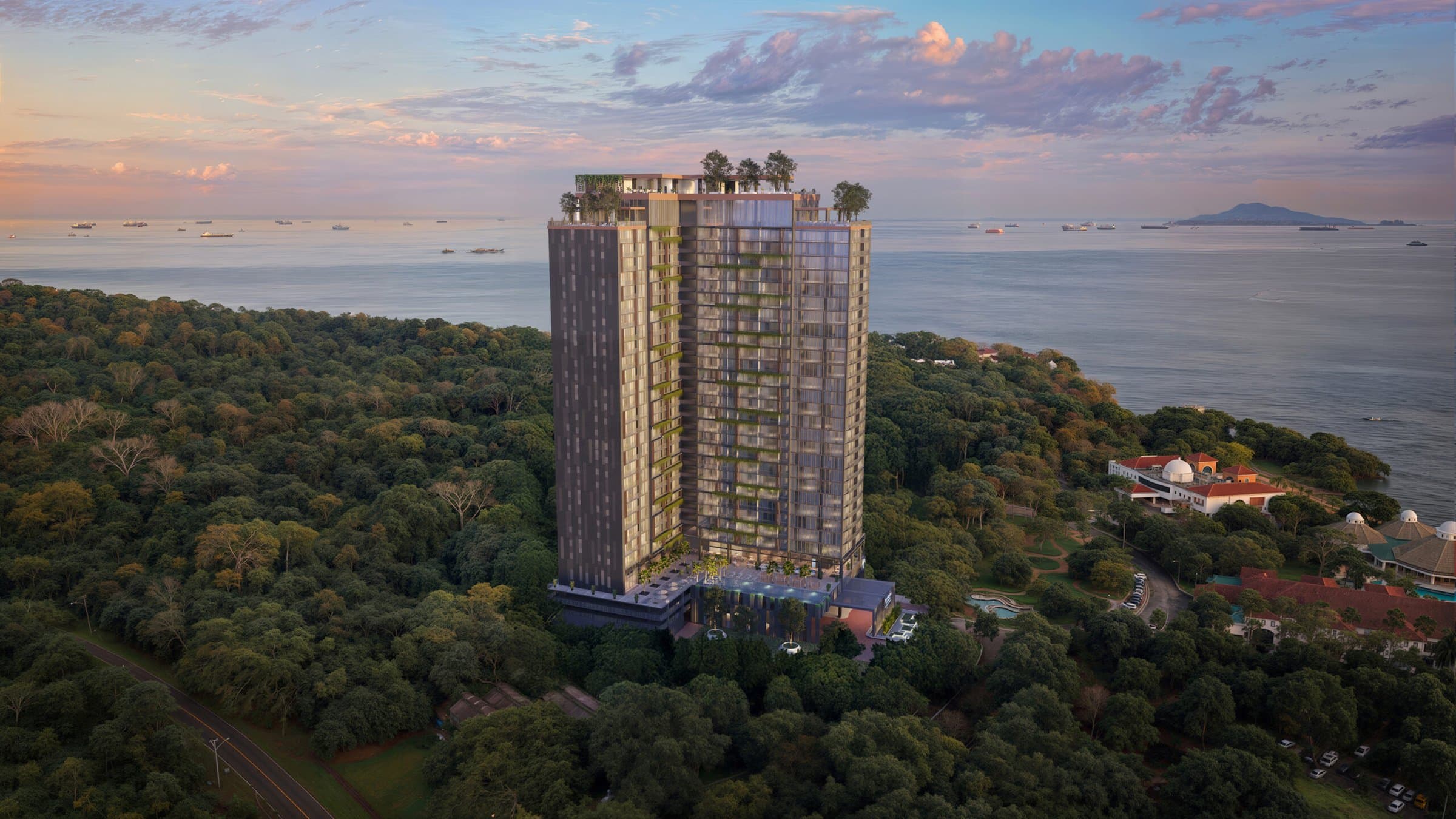 The Westin Residences tower rising above the rainforest at Playa Bonita with the Pacific Ocean behind