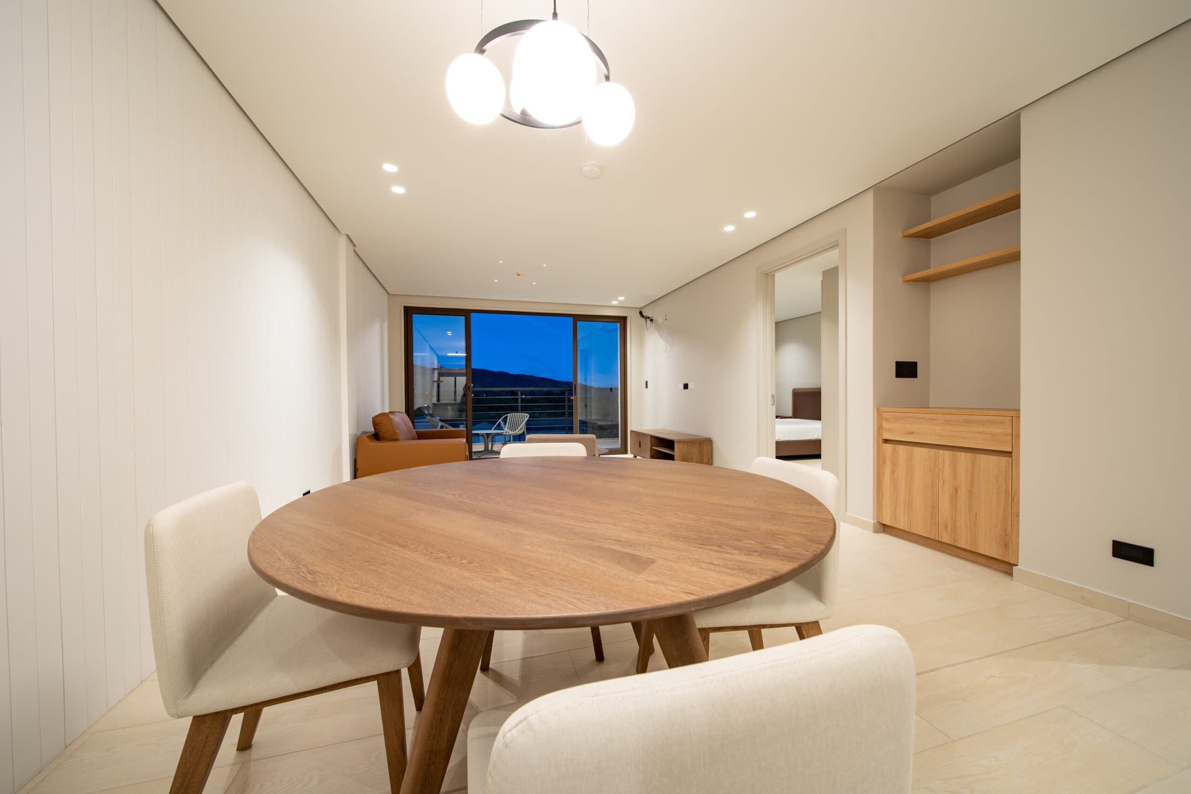 Dining table and open living space inside a Pinoalto condo-suite