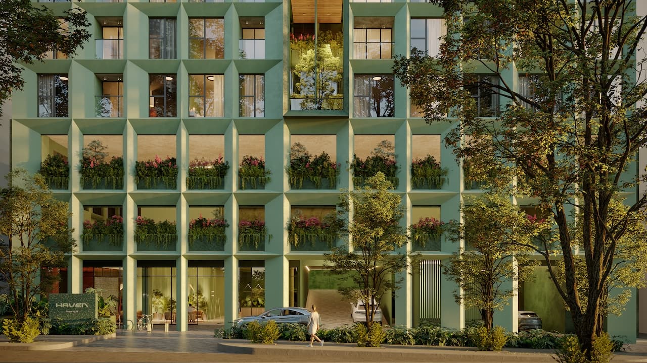 Street-level view of the Haven building and its planted green facade in Obarrio